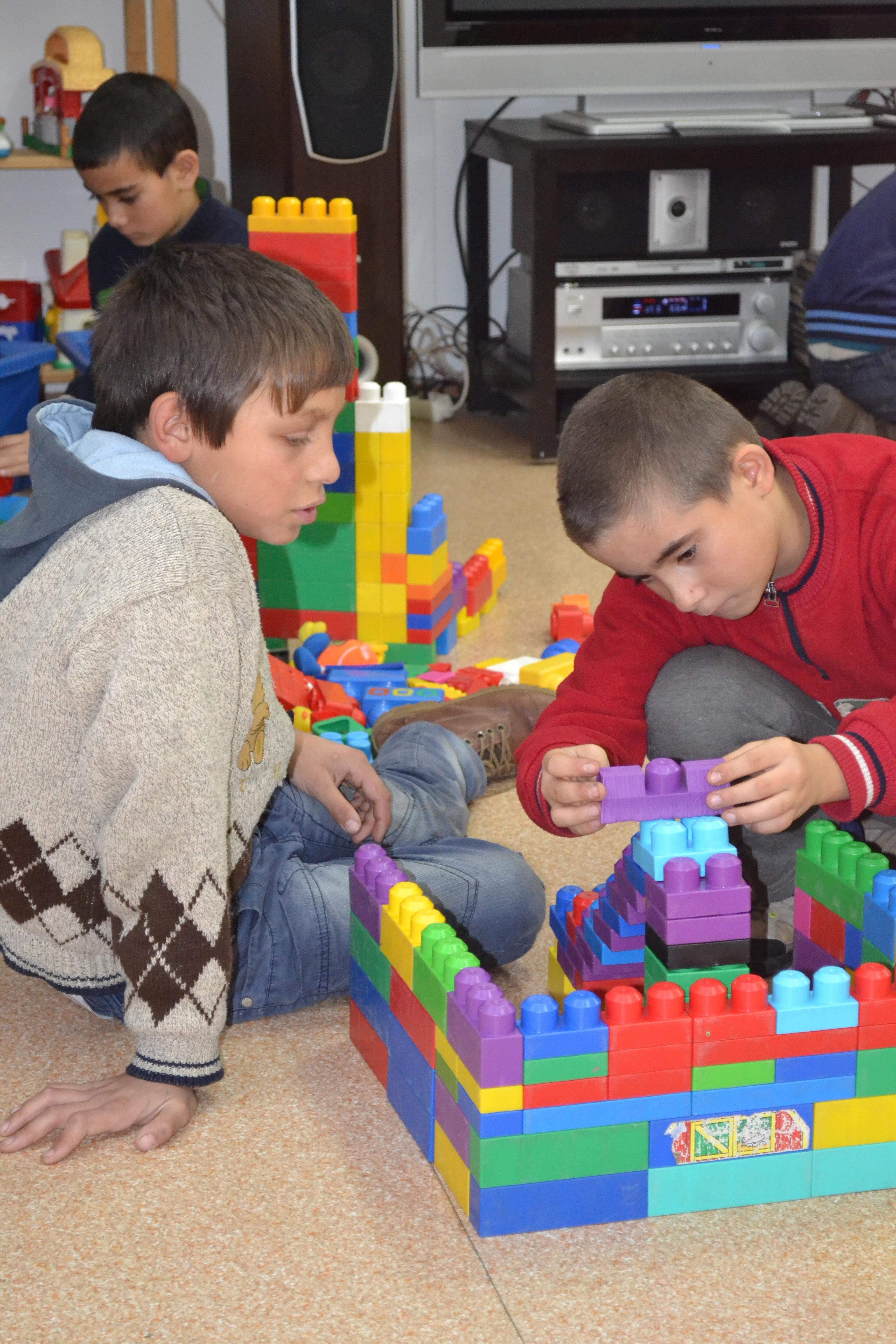 Young kids engage during a classroom activity in Romania Children play with toys during their break at a Childcare placement in Romania